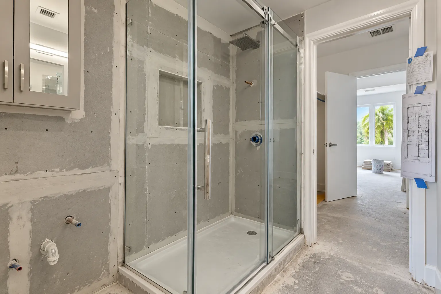 Permit card posted at a bathroom under remodel