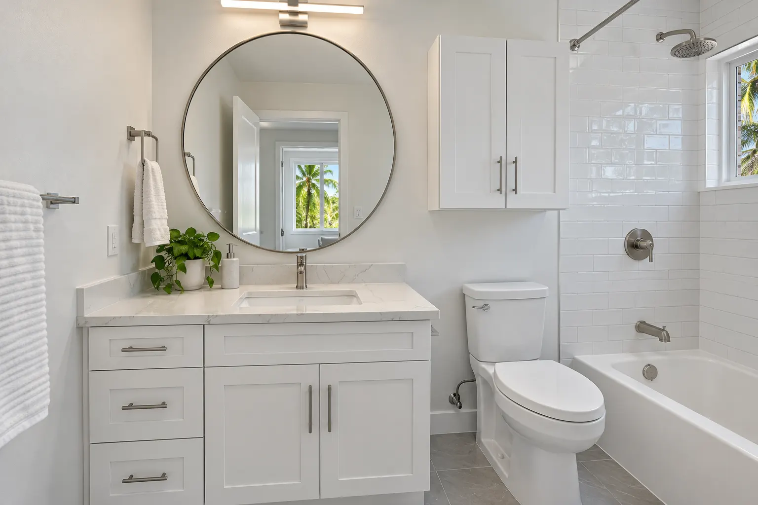 Remodeled hall bathroom with a tiled tub surround